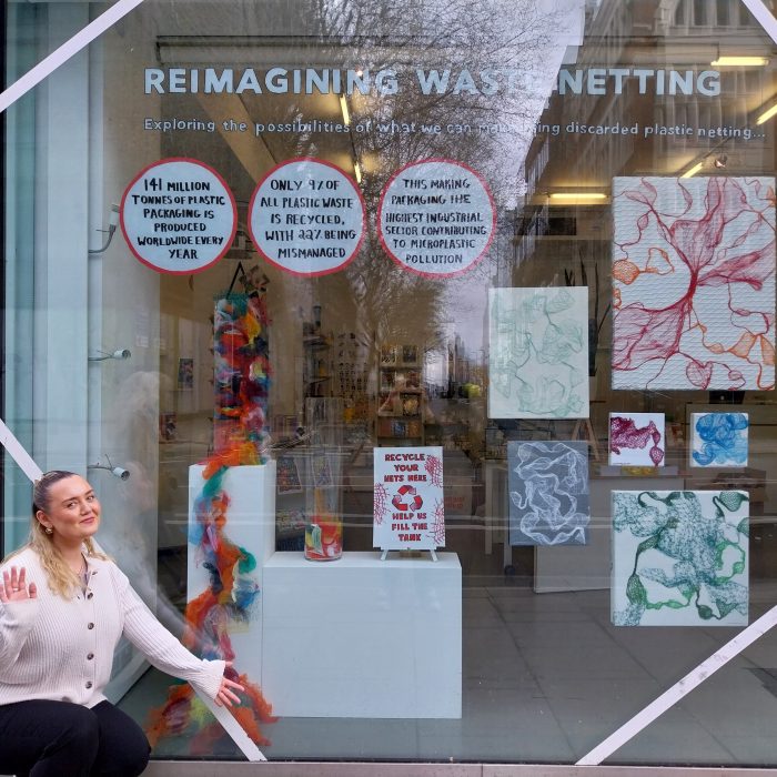 Sanna poses in front of her finished window display