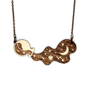 The Spill Necklace, a laser cut wood necklace with a potion of stars spilling out.