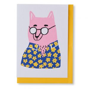 A6 greetings card with an illustration of a pink dog wearing a blue and yellow floral shirt and black glasses. Yellow envelope.