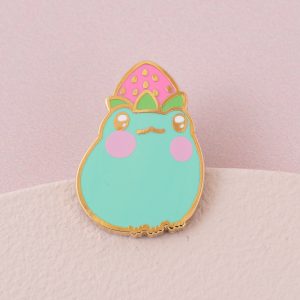 Lily The Frog Enamel Pin -Enamel pin of a green frog with a pink strawberry balanced on it's head