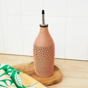 Ceramic oil bottle in coral with a crackling effect finish