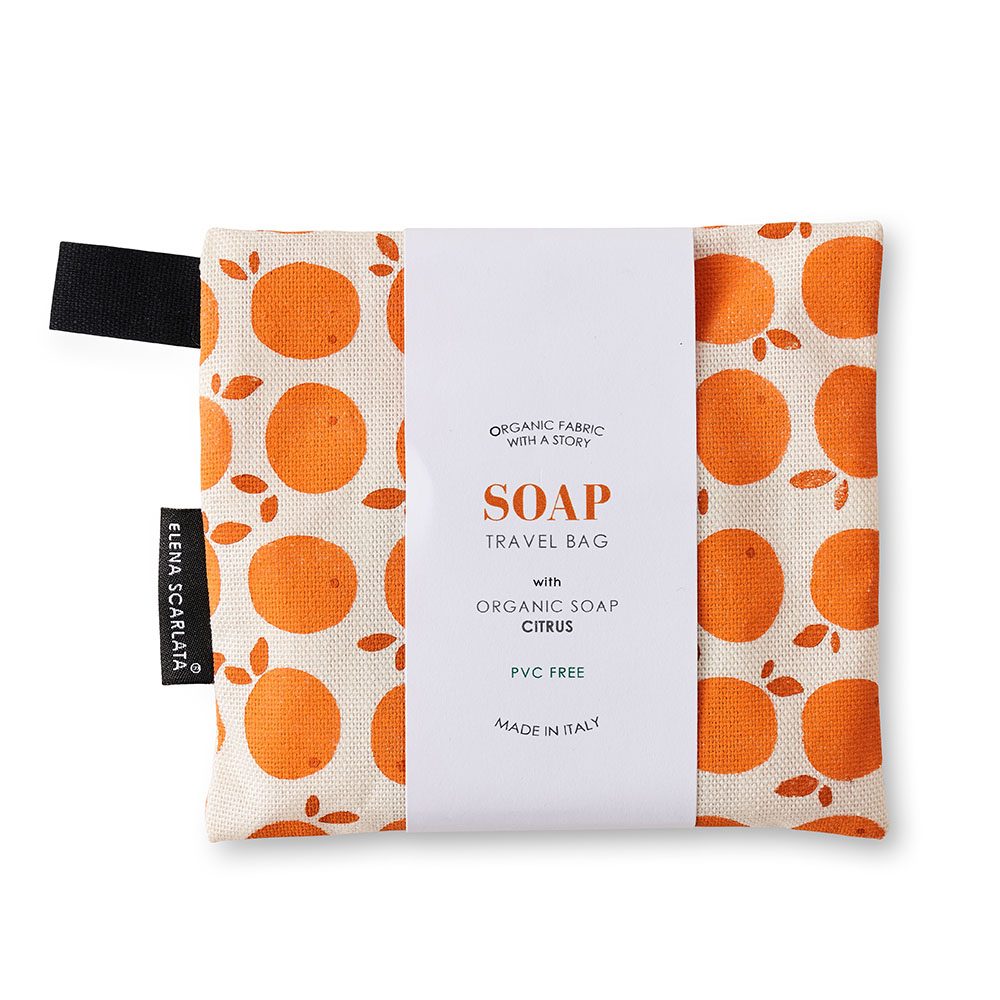 A travel bag with organic soap inside featuring an orange print.