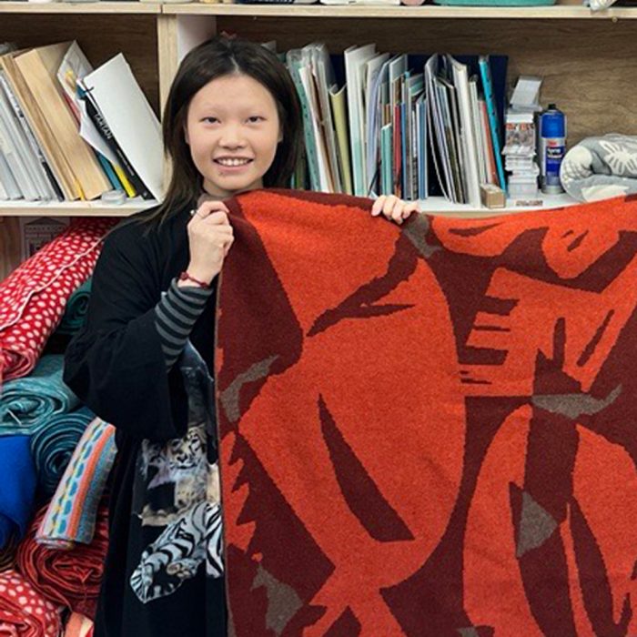 Doudou Huang profile image, holding breadworld blanket in red colour variety