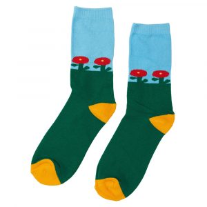 A pair of socks knitted to look like the bottom of the foot is grass, and the ankle is sky with red flowers growing out of the grass.