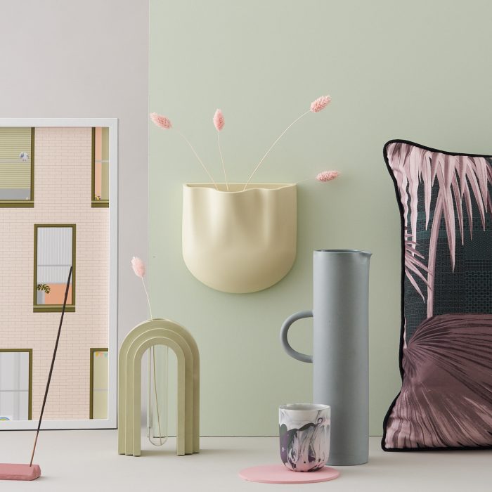 Selection of homeware and decorative products on a light green background.