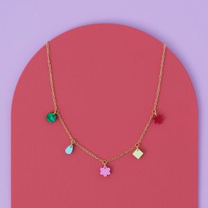 Silver chain multi-coloured charm necklace on a pink and lilac background.