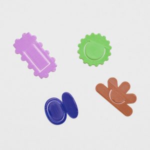 Four page makers in different shapes and colours. One is rectangular with bubbled edges in lilac, the second is sun shaped in a lime green colour. The third is formed of two oval shapes atop each other in a navy blue, and the third is shaped in a half flower in brown.