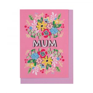 A bright pink card featuring a floral burst of different colours, surrounding the word 'mum' written in white.