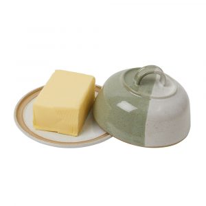 Butter cloche in moss green and white ceramic, with lid off showing full butter block