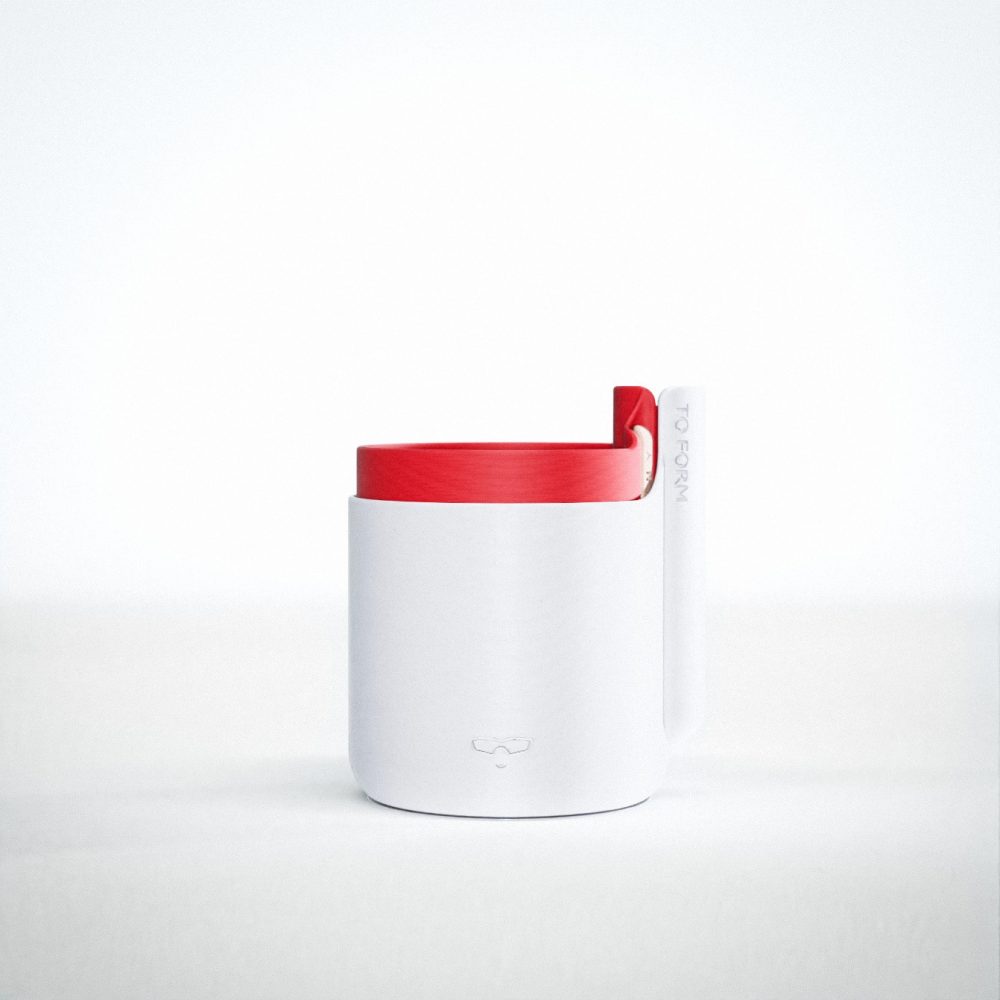 A 3D printed plastic self watering plant pot. The main body is a marbled grey colours, whilst the insert is a Venetian Red. The pot features a logo of a stylised smiling face with sunglasses.