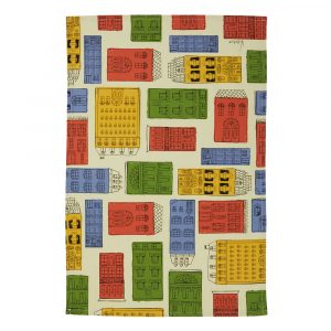 A rectangular tea towel with drawings of houses in primary reds, yellows, blues and green